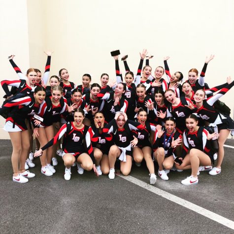 The Lake Oswego High School dance team poses with their trophy after winning tenth place in the Gameday event of the Universal Dance Assocation national competition in Orlando, Florida.